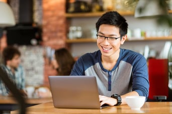 Young Man figuring out his budget in a Topeka coffee shop