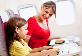 Mother and daughter flying on a plane for Spring Break